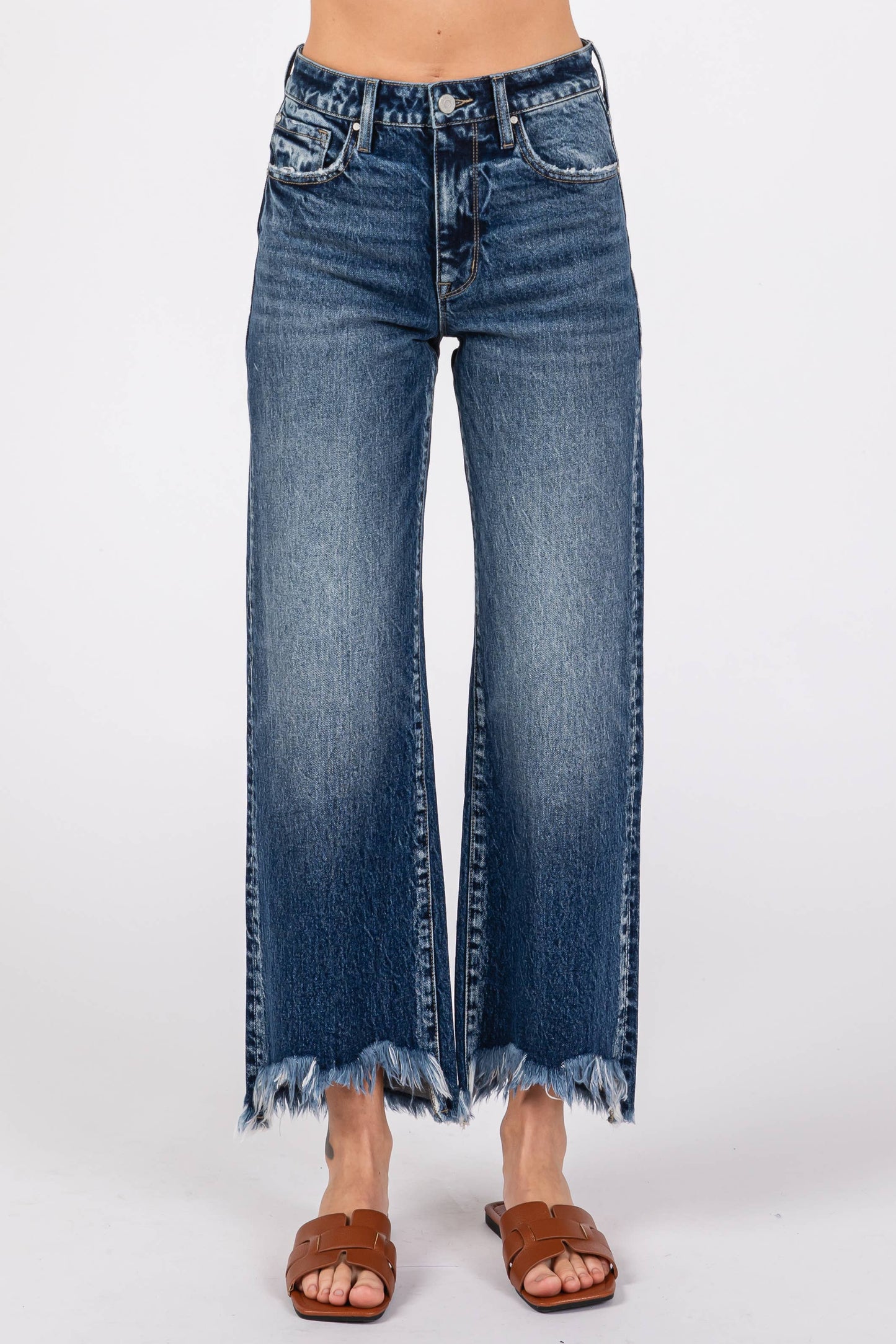 Blue jeans with a frayed hem on a white background
