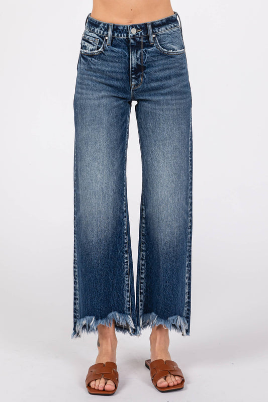 Blue jeans with a frayed hem on a white background