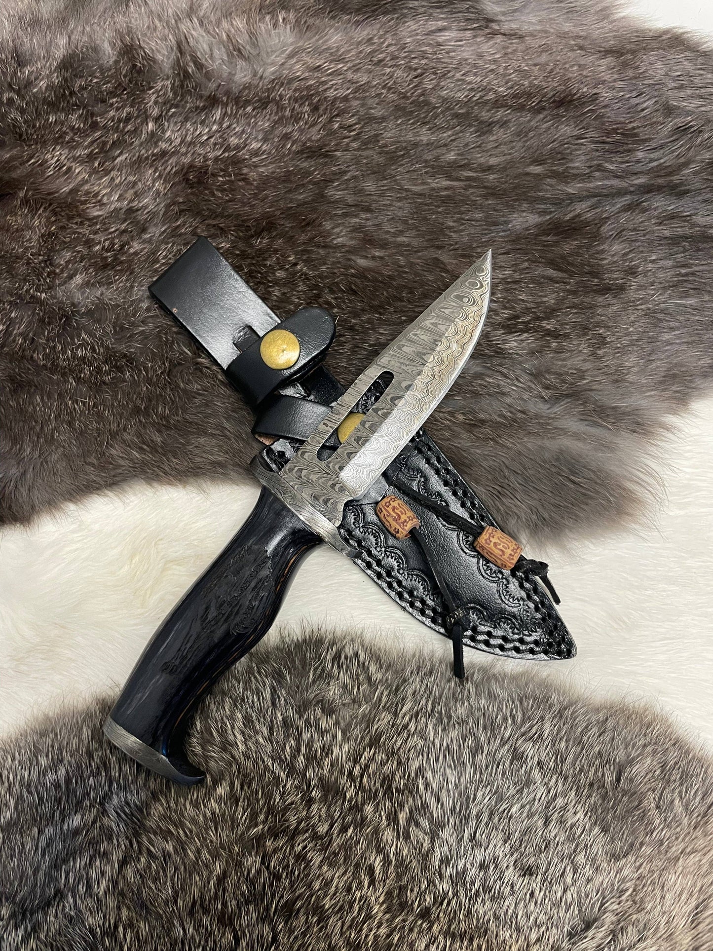 Knife with sheath on a fur surface