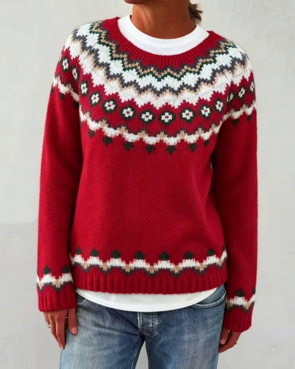 Festive red Faire Isle knit crew sweater over a white T-shirt paired with denim jeans