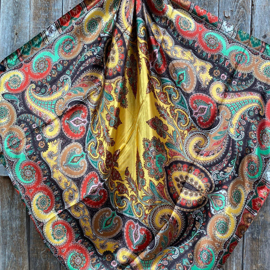 Colorful paisley patterned fabric on a wooden surface