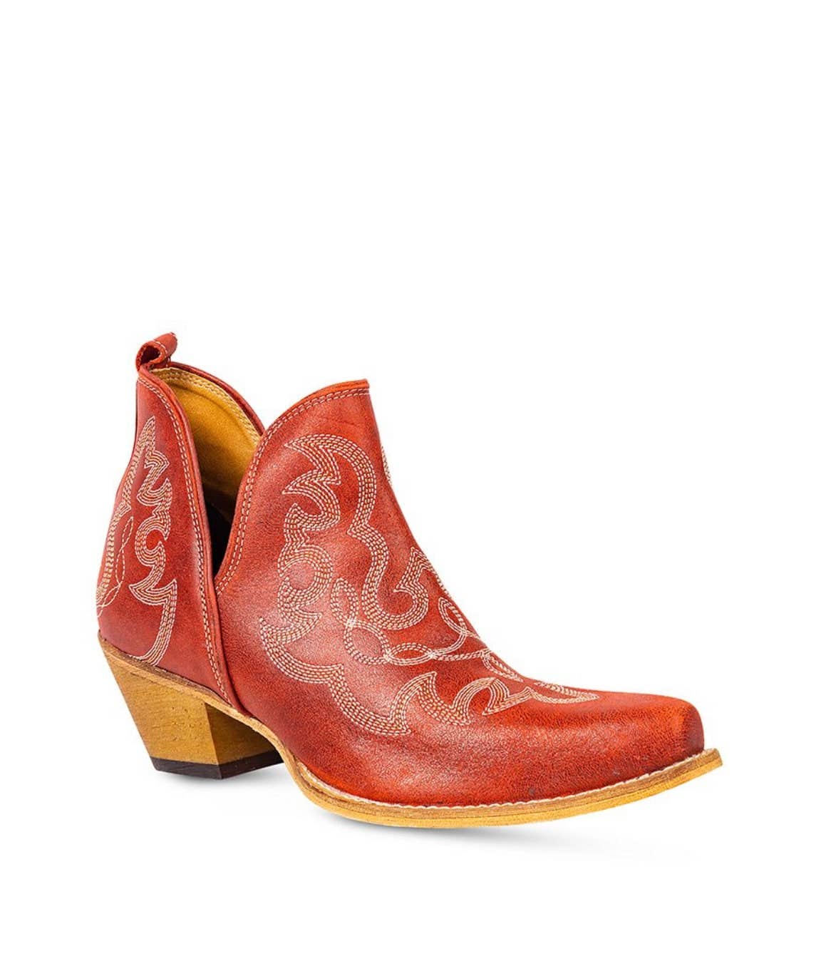 Red cowboy boot with intricate white stitching on a white background