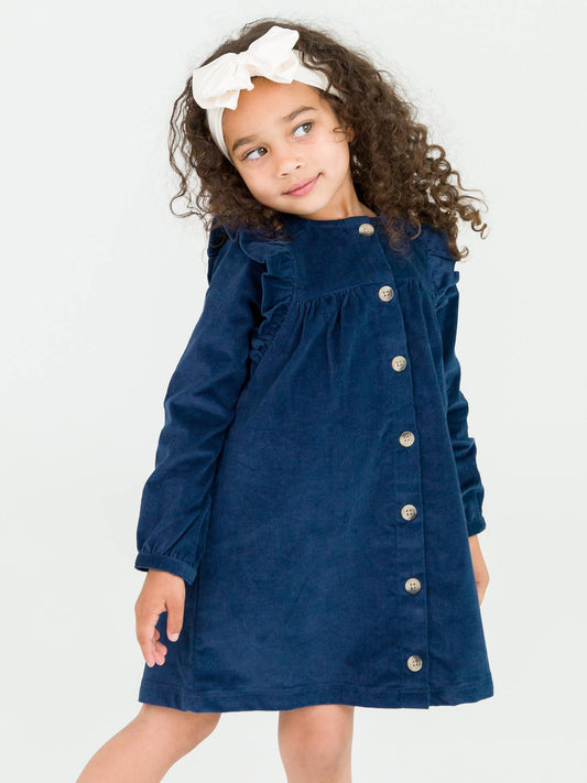 Navy blue corduroy dress for girls with long sleeves, ruffle detail, and button-up front.