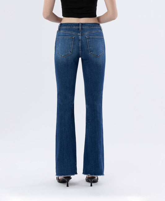 Person wearing blue flared jeans on a white background