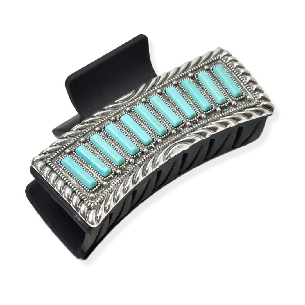 Hair clip with turquoise stones and silver detailing on a white background