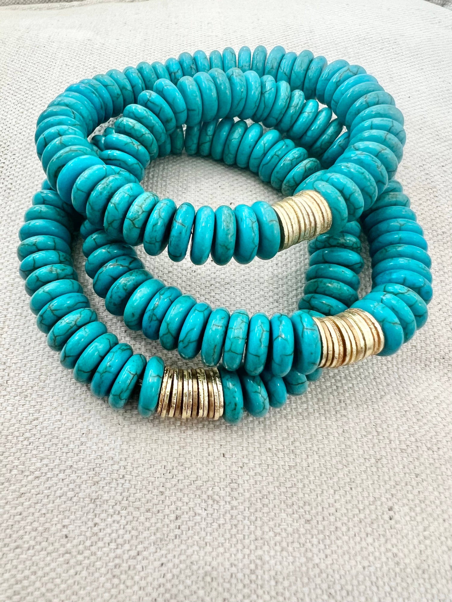 Turquoise magnesite bracelet with gold spacer disks