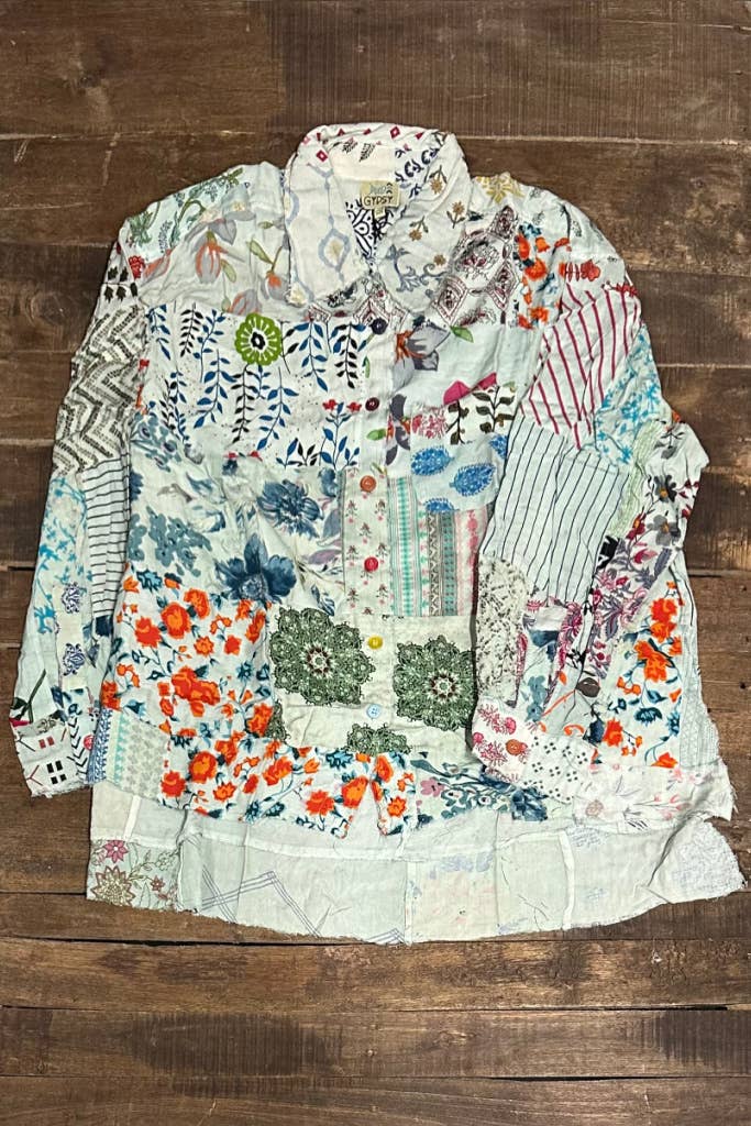 Colorful patchwork shirt on a wooden surface