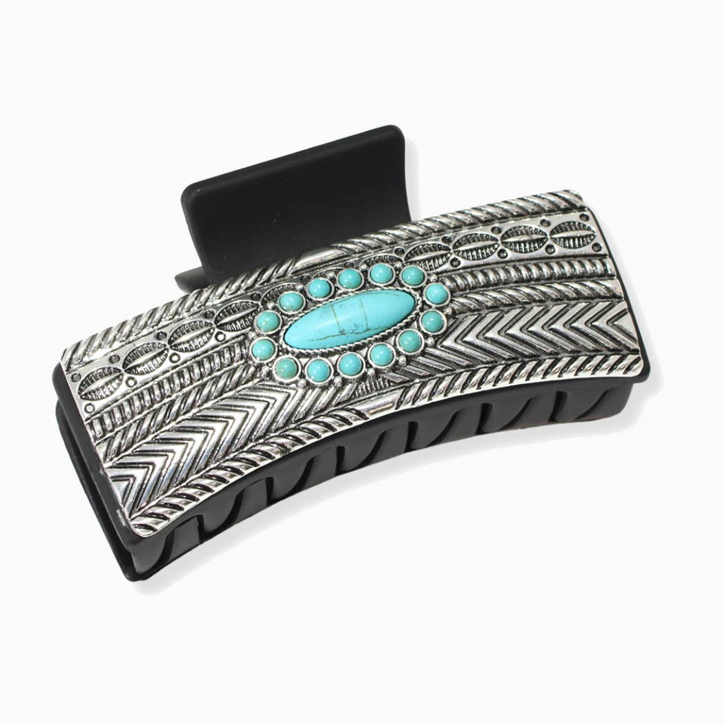 Decorative hair clip with turquoise stones and metallic design on a white background
