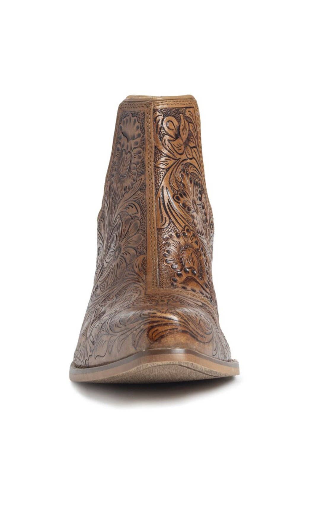A pair of brown, hand-tooled booties with floral patterns.